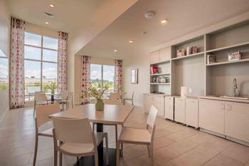 A dining room with a table and chairs